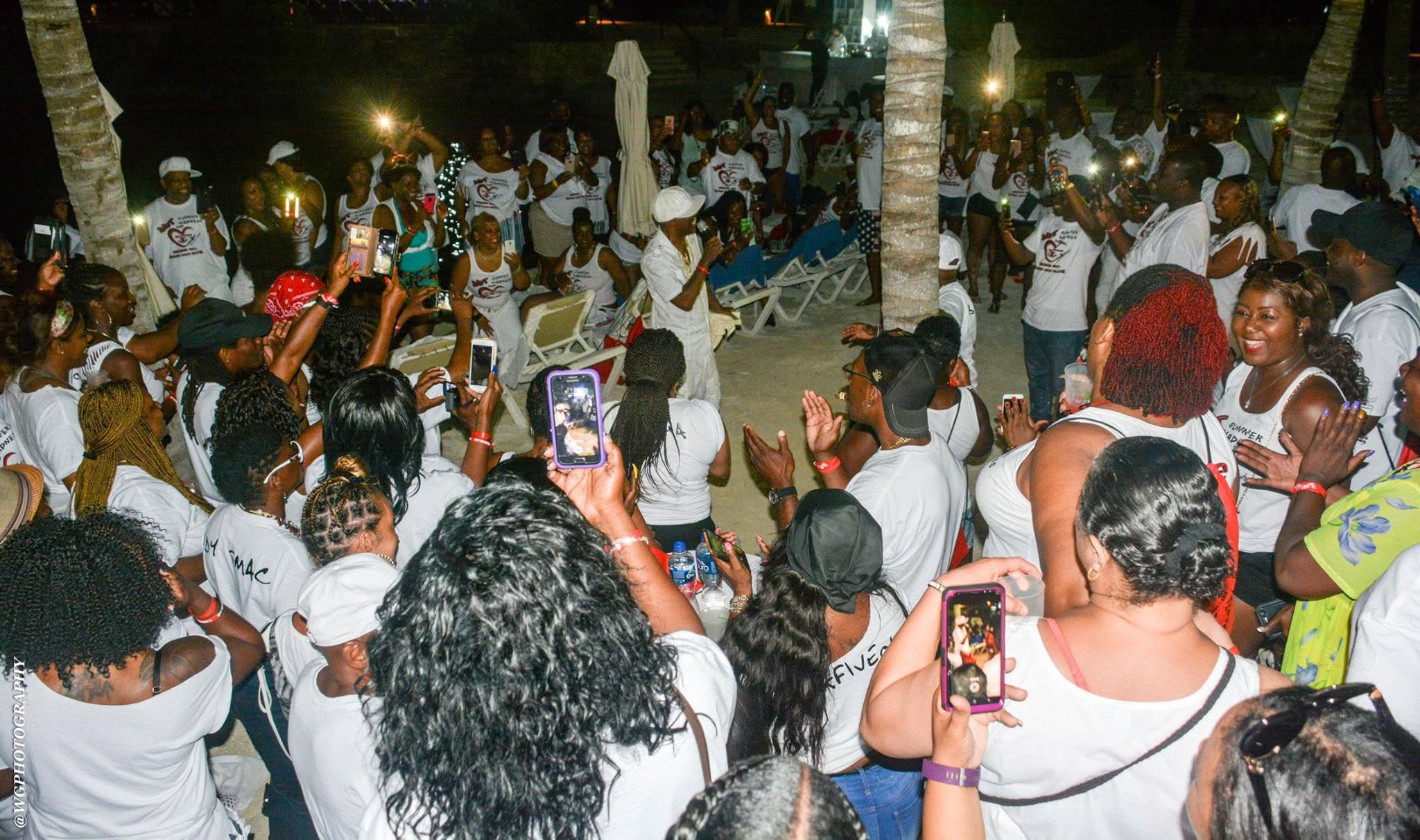 Crowd wearing white shirts at nighttime party