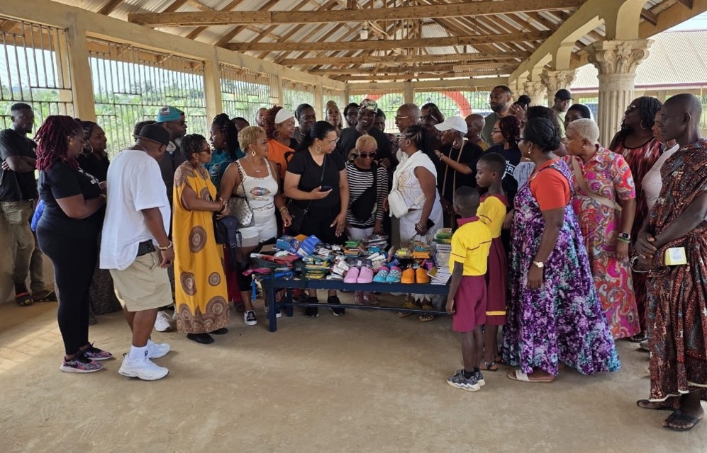 Community group gathered around table of shoes